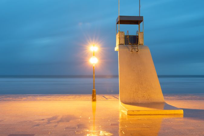 Lonely tower of lifeguard on beach at dusk