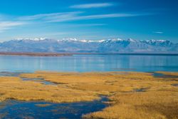 Calm lake and mountain ridge on sunny day
