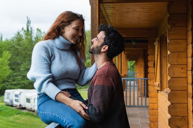 Loving traveling couple chilling on terrace of house