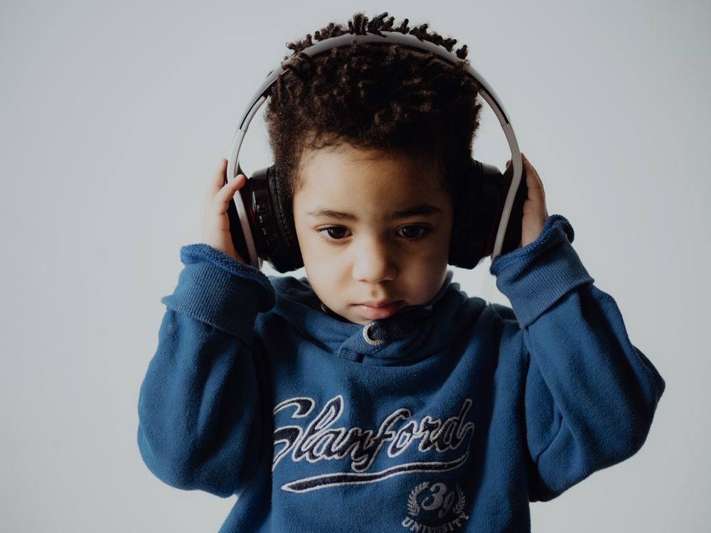 Black child listening to music