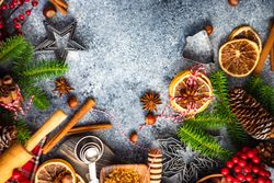 Top view of Christmas baking spices and cookie cutters on counter