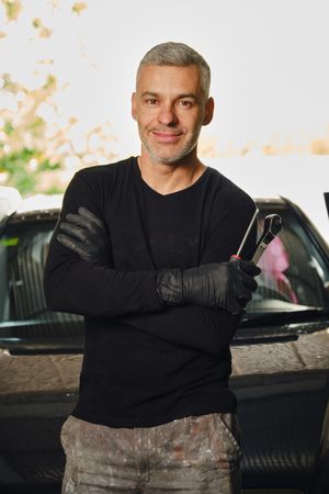 Confident mechanic in garage