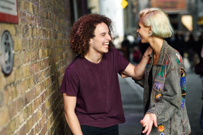 Male and female laughing together on British city street