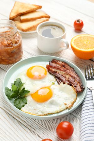 Vertical view of plate of eggs and bacon