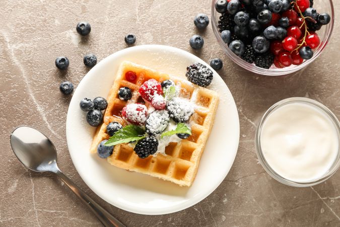 Composition of breakfast with belgian waffle, top view