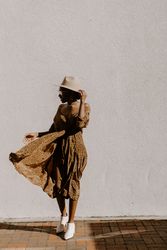 Woman wearing brown dress on a windy day