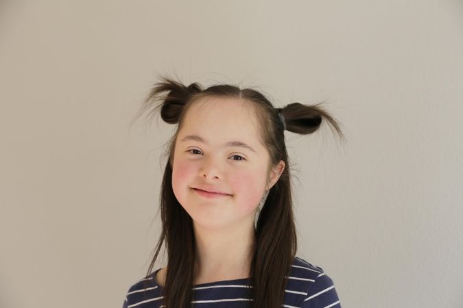 Beautiful child with Down syndrome smiling