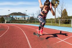 Slim woman running on stadium