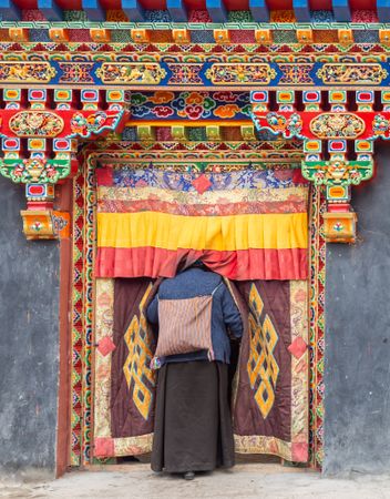 Tibet - August, 29 2014: Anonymous woman entering temple