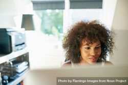 Black female working in her bright home office 5zqAo0
