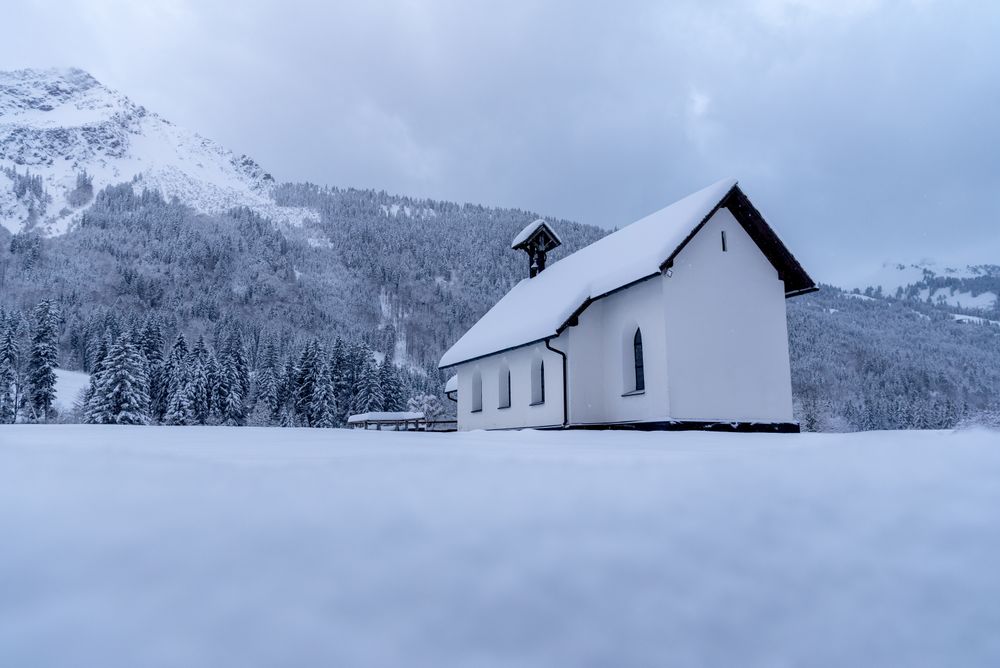 Church minimalist in winter scenery, low angle view in the Bavarian Alps, Germany