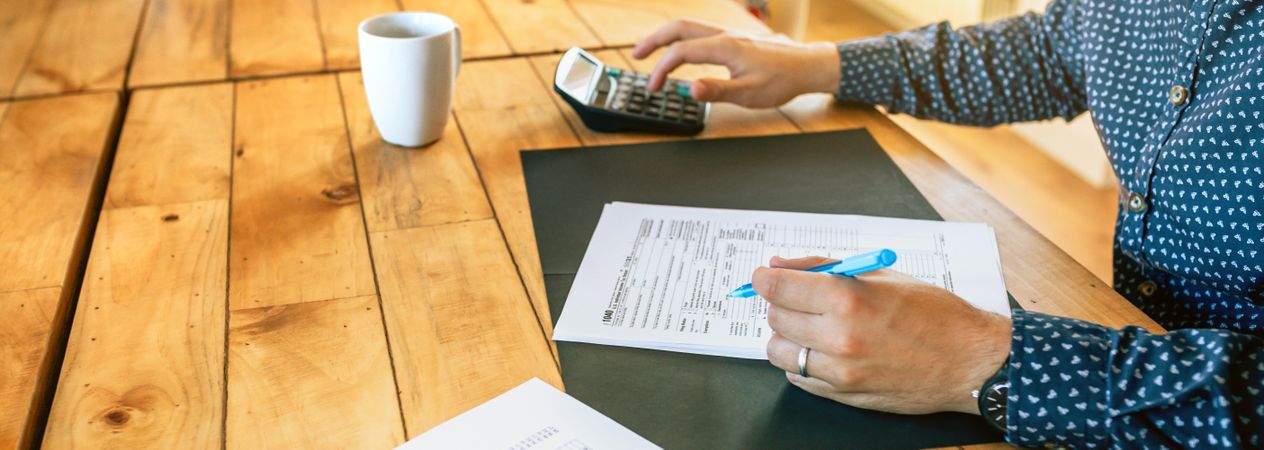 Male adviser filling in tax documents in office