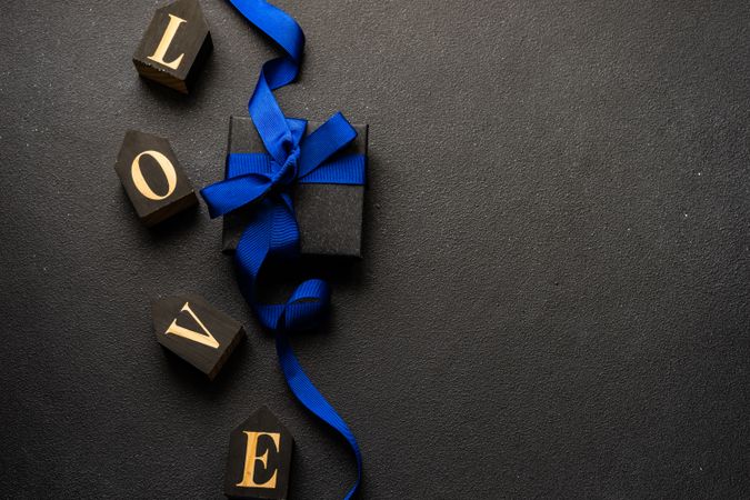 The word "love" next to present with blue ribbon