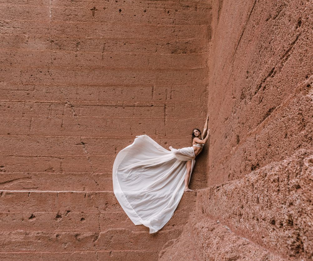 Elegant female posing on rocky cliff