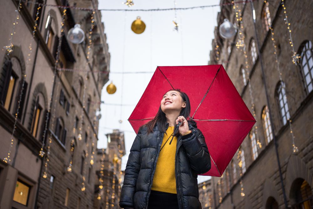 Cheerful Asian traveler exploring old street