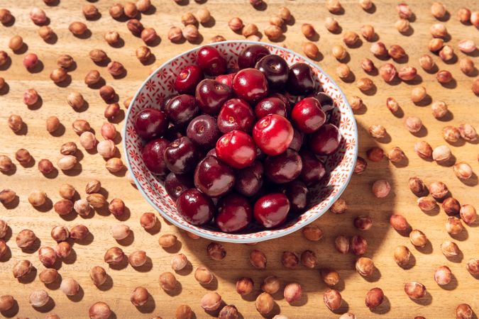 Fresh sweet cherries in bowl and cherry seeds
