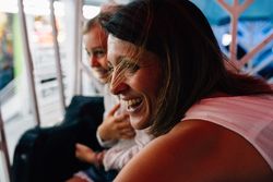 Mother and daughter riding Ferris wheel
