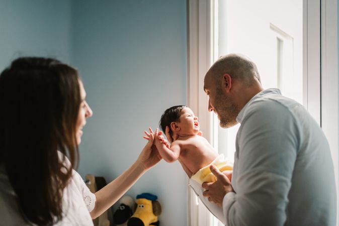 Parents talking to baby in nursery
