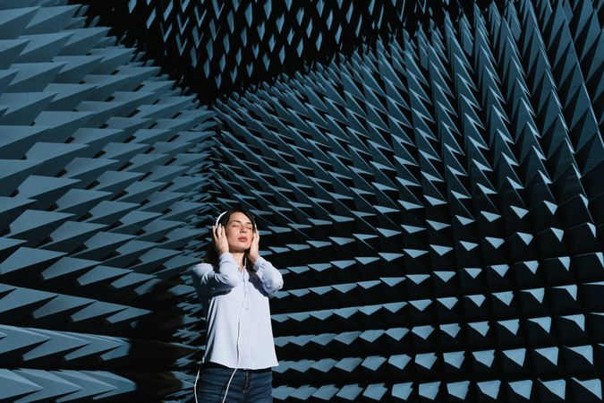Woman in sound room listening to music