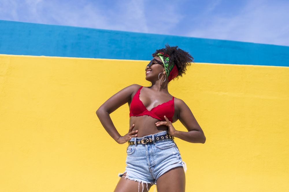 Fun Black woman smiling with hands on hips