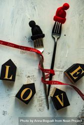 Love spelled in blocks on table with cutlery 5XrrWM