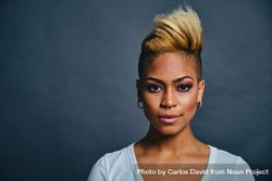 Portrait of Black woman with short blonde hair against gray background with copy space beGEN5