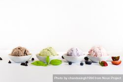 Side view of four small bowls of different flavors of ice cream 0WY2j4