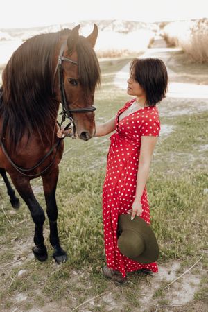 Young woman with horse on ranch