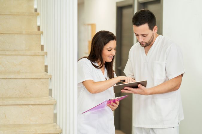 portrait of two physiotherapists looking at the following patien