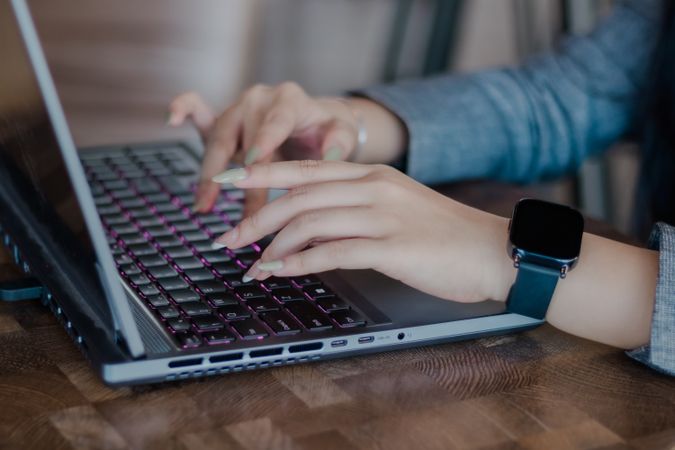 Woman Working on a Sleek Laptop, Showcasing Modern Technology