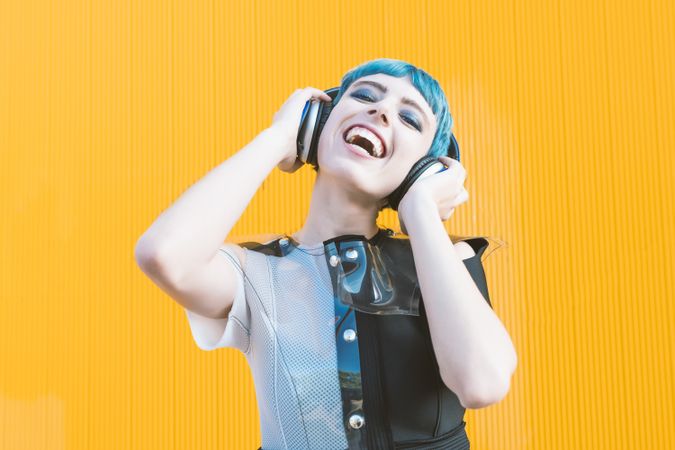 Cool informal woman in headphones on street