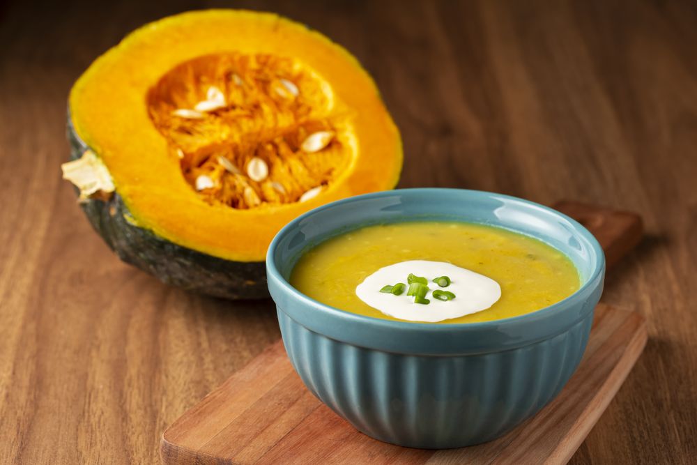 Bowl with pumpkin soup on the table.