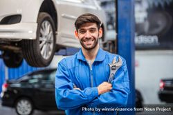 Portrait of automotive mechanic man holding wrench 0vPRL4