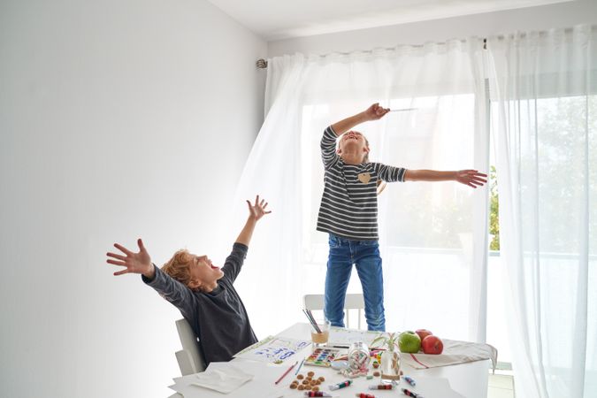 Excited siblings having fun at home