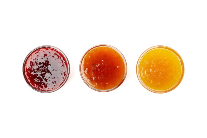 Bowls with jam isolated on plain background, top view