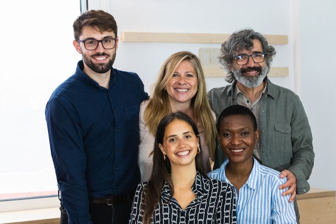 Cheerful diverse coworking women looking at camera