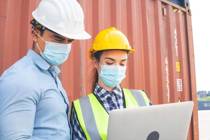 Two people wearing protective mask on site during Coronavirus pandemic