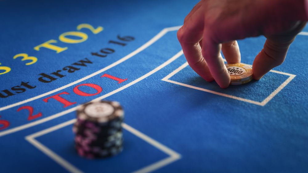 Close Up on Casino Baccarat Gambling Table: Anonymous Croupier Dealing Playing Cards on a Table