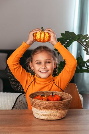 Little Girl Playing With a Pumpkin.