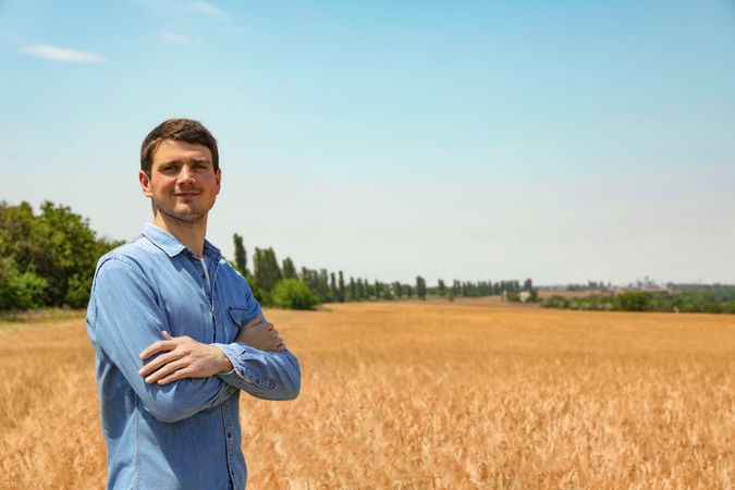 Young man in barley field. Agriculture business. Farming