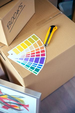 Detail of color palette and cutter over moving boxes