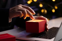 Businessman Reaching Into Glowing Sphere