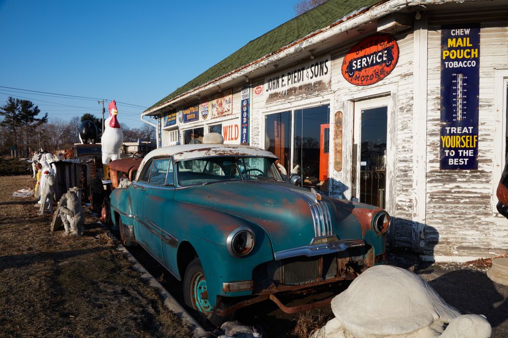 An old car and an oversized chicken figure, Benton Harbor, Michigan