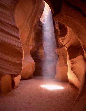 Sun beam in curvy red rock walls of Antelope Canyon