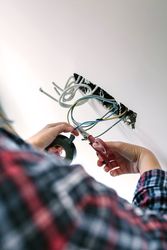 Unrecognizable electrician working on the electrical installation of a house