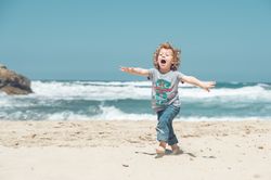 Carefree boy running on beach