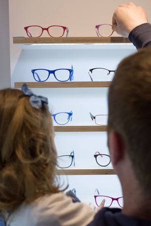 Young girl trying on glasses