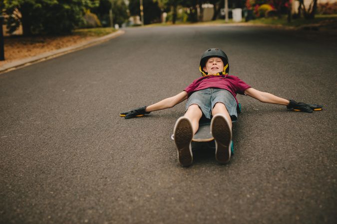 Playful boy skateboarding outdoors