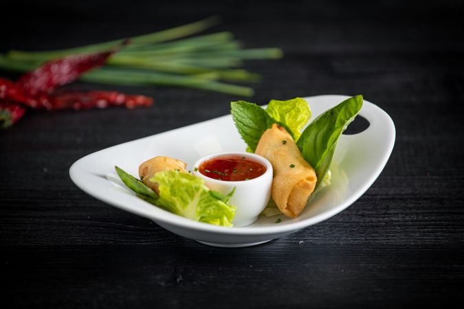Vietnamese rolls with sweet chili on glass plate