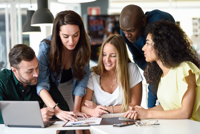 Multi-ethnic group working in office together
